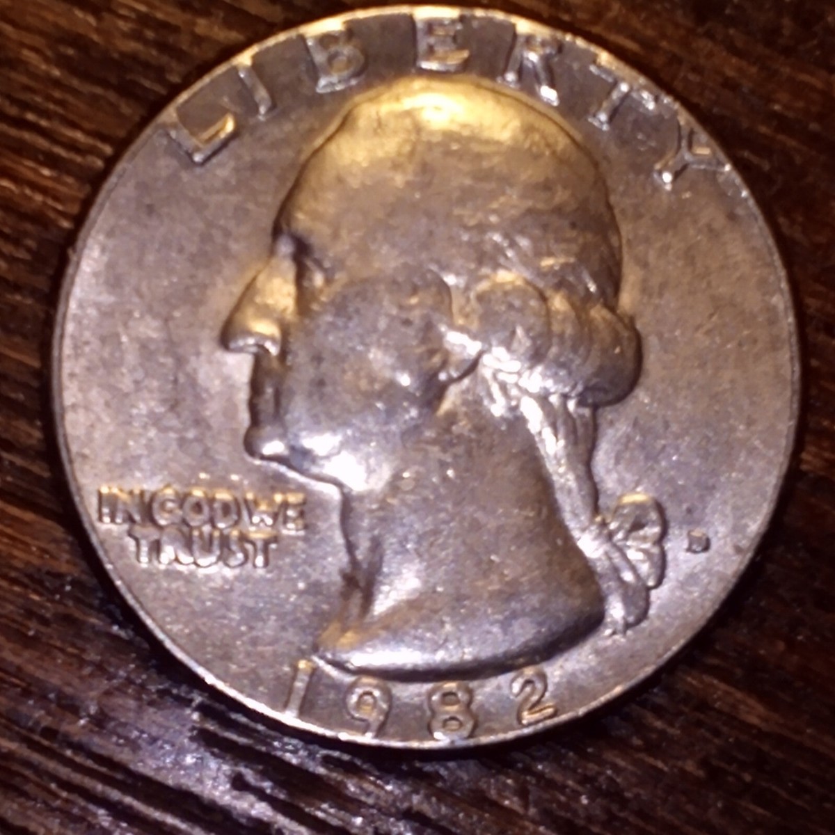 1982 quarter struck on nickel planchet shown beside normal quarter illustrating size difference