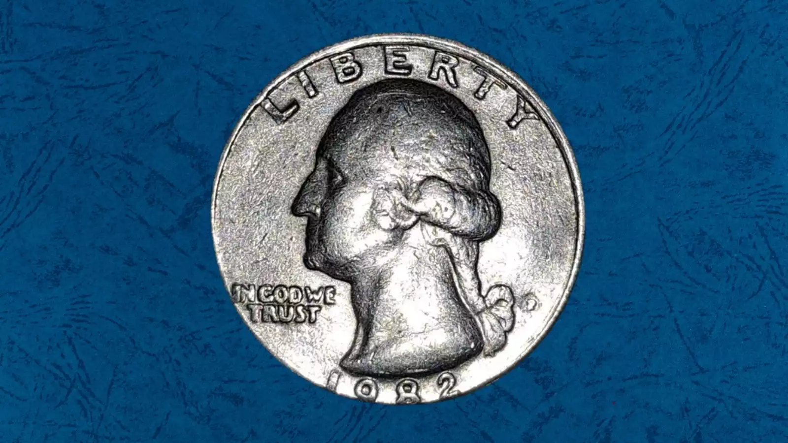 1982 quarter dramatic off-center strike showing crescent blank area and visible date